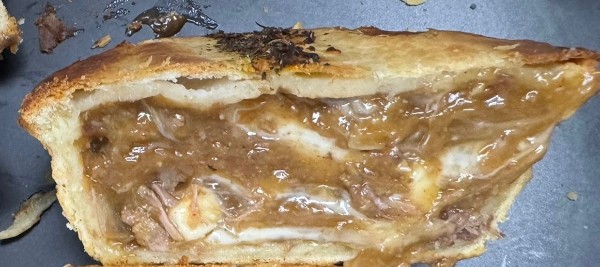 Meat pie cross-section with heat resistant cheese